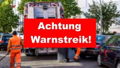 Verschwommenes Foto von einem Müllwagen, davor ein Warnschild mit dem Text "Achtung Warnstreik!"